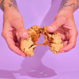Crumbs & Doilies Salted Caramel Pecan New York Cookie pulled apart to reveal gooey salted caramel centre.